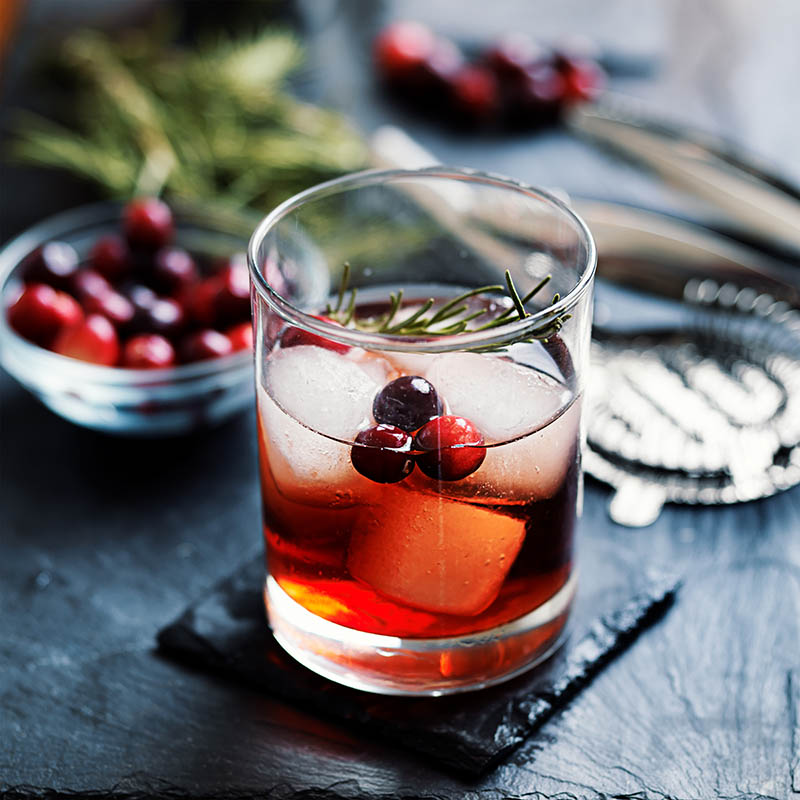 cocktail cranbbery and rosemary on slate coaster cocktail